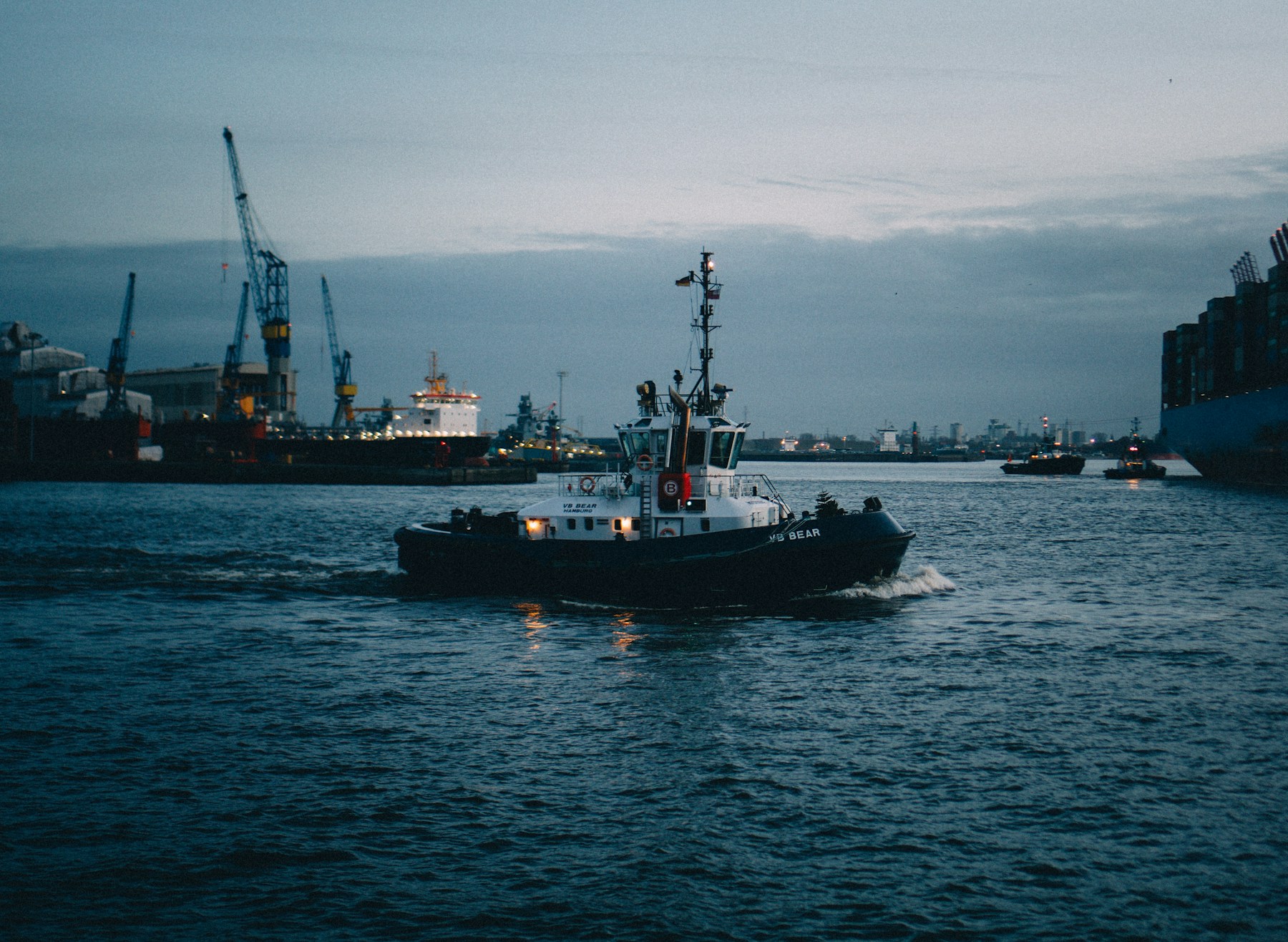 Illustrative photograph of a tugboat in a commercial harbour